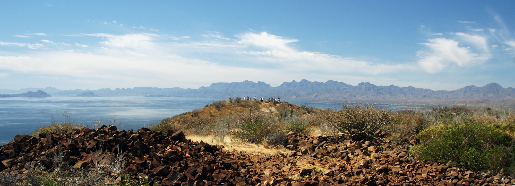 Hikers on a ridge above the Sea of Cortez with the Sierra de la Giganta behind