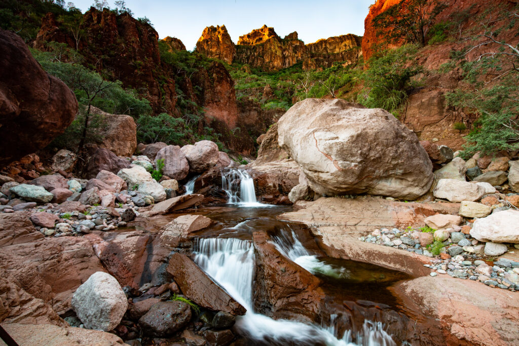 Waterfall and red rock walls in Tabor Canyon